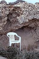 A chair sheltered from the wind